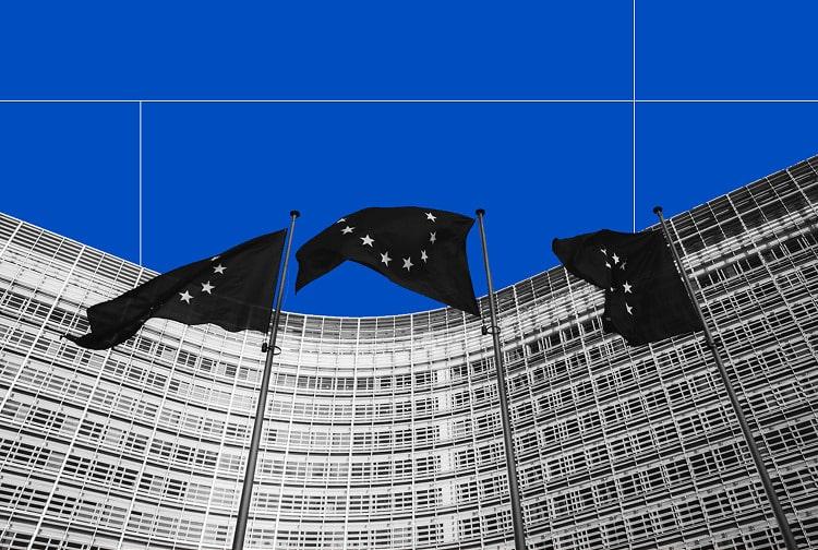 European Union flags in front of the European Commission building, representing the governance of GO registries in Europe.